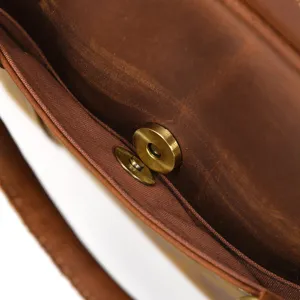 Genuine leather briefcase interior detail showcasing metal magnetic snap and lining.