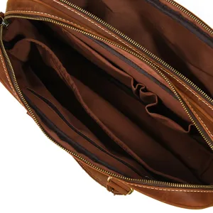 Interior view of brown leather briefcase for men, featuring multiple storage compartments and zippers.