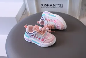 Close-up view of pink breathable mesh kids sports sneakers with a thick white rubber sole