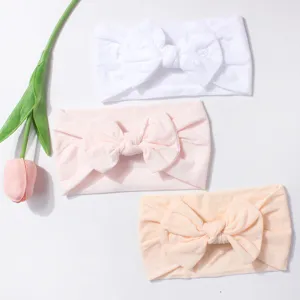 Soft nylon baby headbands featuring oversized bows in pastel colors for comfortable wear