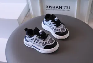 Close-up of breathable mesh toddler sneakers with stylish cage overlay design.