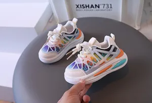 Close-up of breathable mesh toddler sneakers with vibrant rainbow pattern details.