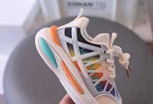 Close-up of children's mesh athletic shoes showing breathable colorful gradient detail