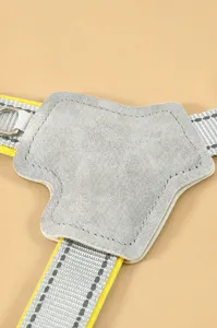 Close-up of pet harness suede padding and reflective webbing, soft and comfortable touch.
