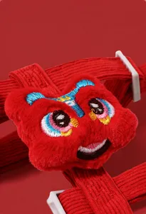 Red Chinese lion dance pet harness detail shot showing cute plush embroidered design and durable strap.