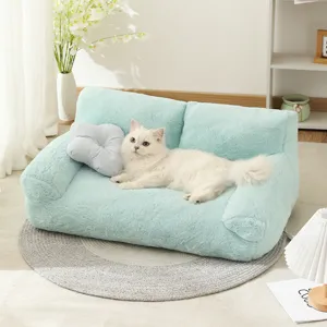 Cozy mint green plush pet sofa bed with cute flower pillow for cats and small dogs in winter.