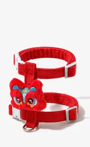 Chinese style lion dance pet harness detail view, red corduroy cat leash with plush decoration.