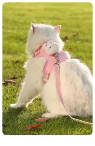 Cute pink cat harness and leash set detail view featuring fluffy bunny decor outdoors.