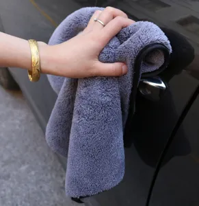 Close-up view of thick microfiber car washing towel cleaning handle, soft plush texture.
