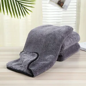 Detailed view of thick microfiber car washing towel, soft coral fleece in dark grey with black trim.