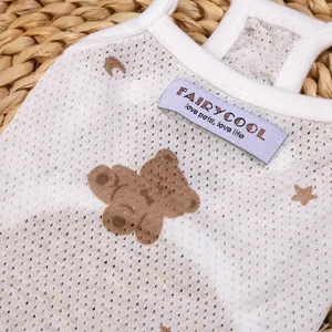 Detailed shot of summer breathable pet dog vest, white mesh fabric with cute cartoon bear print.