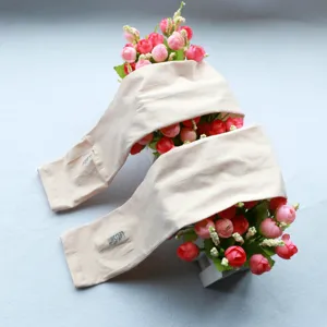 Detail view of beige sun protection cooling arm sleeves with brand text, outdoor gear.