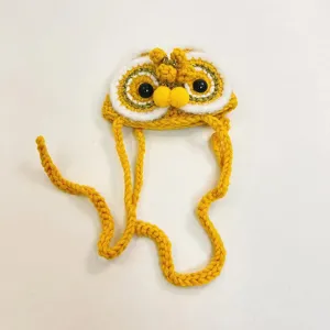 Detailed view of cute Chinese style lion dance cat hat, handmade knitted pet accessory.