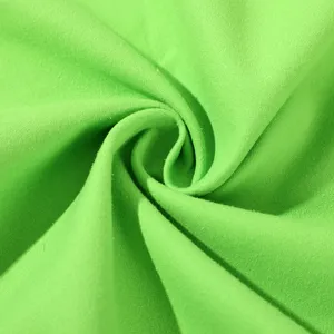 Detailed close-up of a vibrant green cooling sports towel, showing soft and quick-drying fabric.