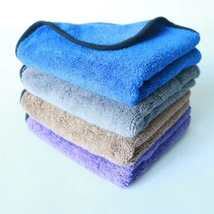 Detailed view of folded microfiber cleaning towels in assorted colors for car care.
