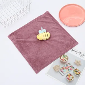 Detailed view of the cute cartoon bee plush hand towel, soft coral fleece texture.