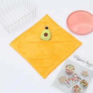 Detailed close-up of yellow coral fleece hand towel featuring cute avocado plush toy design.