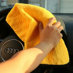 Detailed view of the yellow microfiber car cleaning towel showing plush texture and edge binding.