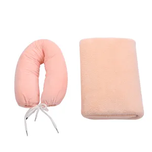 Coral fleece U-shaped travel neck pillow and folding blanket set in soft pink color for cozy trips.