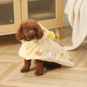 Close-up of a cute pet cloak in soft yellow fleece with adorable cartoon prints and cozy hood.