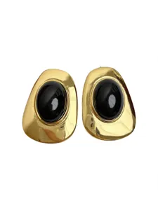 Close up detail of vintage style irregular gold metal earrings with black resin insert.