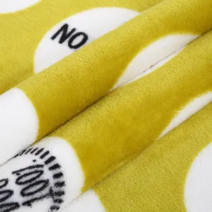 Soft plush pet blanket fabric detail with cute dot print, warm and cozy winter mat material.