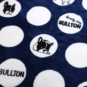 Soft plush pet blanket detail shot, blue fleece with cute dog patterns and cozy texture.