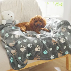 Cozy grey pet flannel blanket with cute paw print patterns, soft and multifunctional for home or office use.