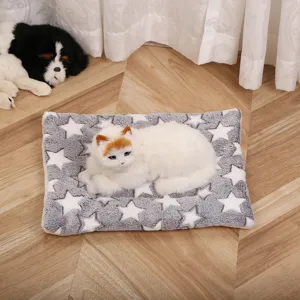 Soft fleece pet blanket with star pattern and realistic plush cat toy detail in a cozy home setup.