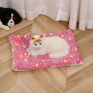 Close-up detail of the thick flannel pet mat with cute colorful paw print design for cozy warmth.