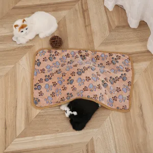 Detailed view of the soft coral fleece pet blanket with cute paw prints for cozy resting.
