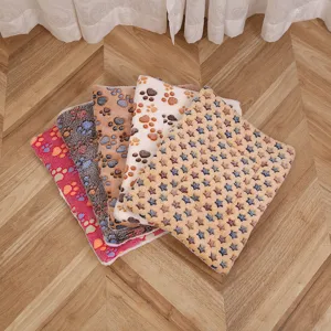 Soft coral fleece pet blanket for cats and dogs, warm printed mat with cute paws and stars.