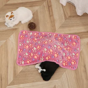 Pink pet blanket detail view showing soft coral fleece texture and cute paw print pattern for cats and dogs.