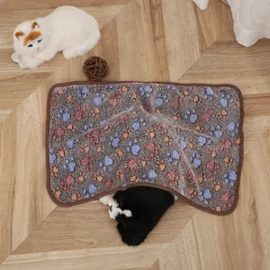 Coral velvet pet blanket detail showing soft paw print fabric pattern and cozy cat mat texture.