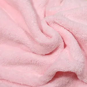 Close up of soft pink coral fleece fabric detail, highly absorbent plush material texture.