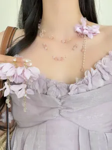 Purple flower beaded necklace and tassel earrings set, elegant resort style detailed view.