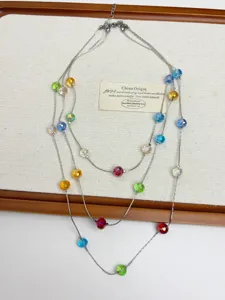 Detail shot of multi-layer colorful crystal beaded necklace, stylish clavicle chain design.