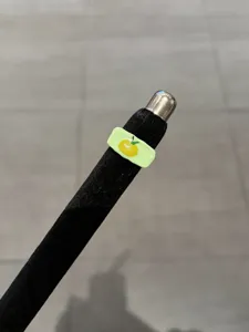 Detailed close-up of a sweet minimalist enamel ring featuring a cute yellow fruit motif on green.