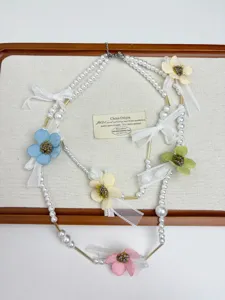 French style romantic pearl necklace with colorful fabric flowers and lovely white lace bows.
