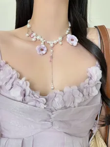 Korean style floral pearl tassel necklace close-up, elegant purple clavicle chain detail.