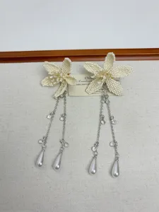 Elegant beaded flower long tassel earrings, white seed bead floral design with silver chains.