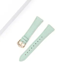 Mint green cowhide watch strap, lychee grain leather, elegant design with gold buckle detail.