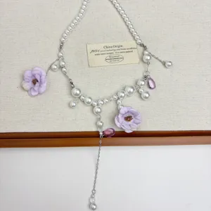 Korean style flower pearl tassel necklace with purple fabric flowers and crystal pendants.