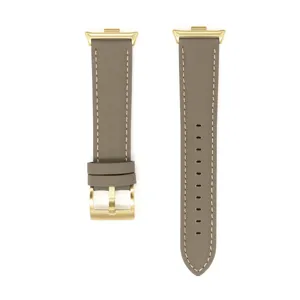 Cinturino di ricambio in pelle grigio-marrone con fibbia e connettore dorati per smartwatch.