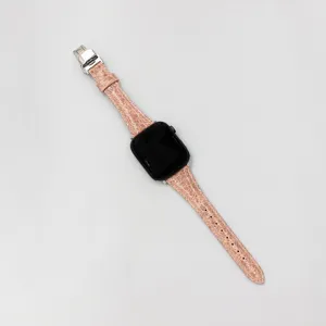 Detailed view of luxury genuine leather watch strap with metal butterfly clasp in unique texture.