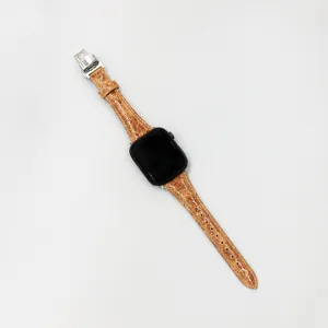 Detailed view of the premium brown leather watch strap with a secure silver butterfly buckle.