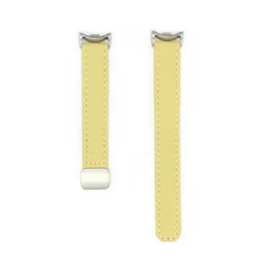 Detailed view of the yellow leather watch strap featuring litchi texture and magnetic buckle.
