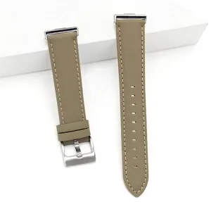 Detail view of taupe genuine leather watch strap with stainless steel buckle and neat stitching.