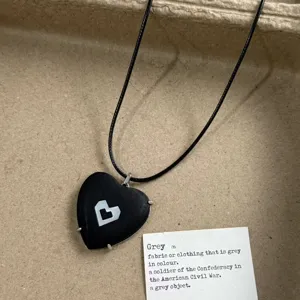 Black heart pendant necklace with black cord and descriptive card for daily fashion wear.