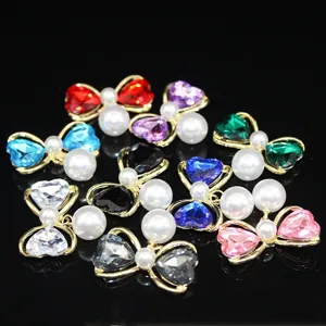 Detailed view of DIY bow charm accessories featuring colorful heart crystals and faux pearls.